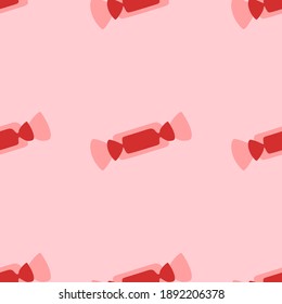 Seamless pattern of large isolated red candy symbols. The elements are evenly spaced. Vector illustration on light red background