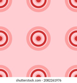 Seamless pattern of large isolated red astrological sun symbols. The elements are evenly spaced. Vector illustration on light red background