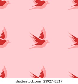Seamless pattern of large isolated red bird symbols. The elements are evenly spaced. Vector illustration on light red background