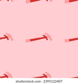 Seamless pattern of large isolated red hammer symbols. The elements are evenly spaced. Vector illustration on light red background