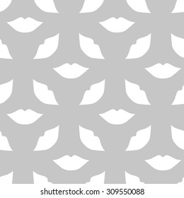 Seamless pattern of large silhouettes of kissing lips white on a gray background