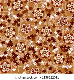 Seamless pattern of large and small abstract flowers. Against the background of an old network consisting of lines intersecting at right angles.