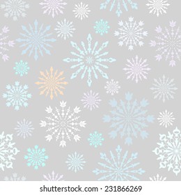 Seamless pattern with large and small blue, grey, lilac carved snowflakes on pale background