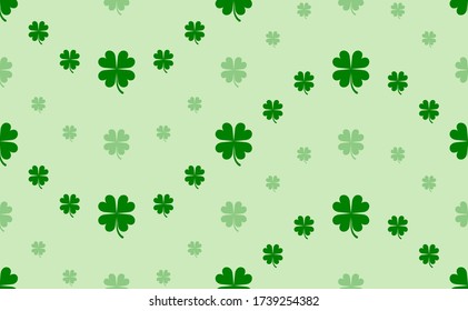 Seamless pattern of large and small green four-leaf clover symbols. The elements are arranged in a wavy. Vector illustration on light green background