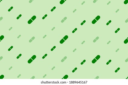 Seamless pattern of large and small green medical capsule symbols. The elements are arranged in a wavy. Vector illustration on light green background