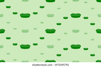 Seamless pattern of large and small green hotdog symbols. The elements are arranged in a wavy. Vector illustration on light green background