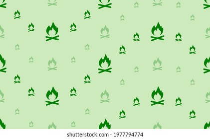 Seamless pattern of large and small green bonfire symbols. The elements are arranged in a wavy. Vector illustration on light green background