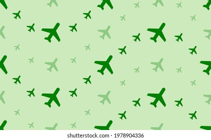 Seamless pattern of large and small green plane symbols. The elements are arranged in a wavy. Vector illustration on light green background