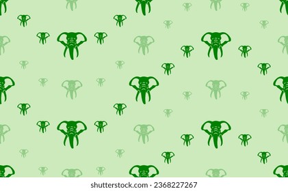 Seamless pattern of large and small green elephant heads. The elements are arranged in a wavy. Vector illustration on light green background
