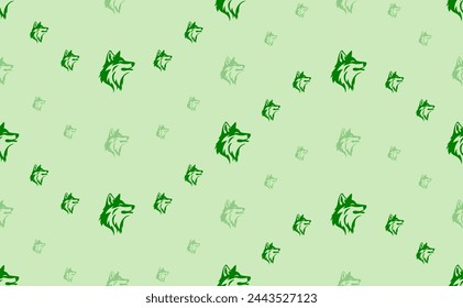 Seamless pattern of large and small green wolf heads. The elements are arranged in a wavy. Vector illustration on light green background