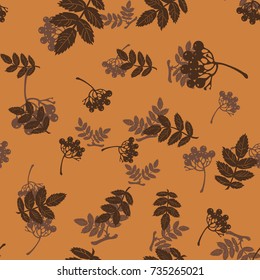 seamless pattern with leaves and berries of mountain ash on a light brown background