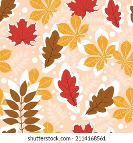Seamless pattern with leaves in the fall season on a peach color background