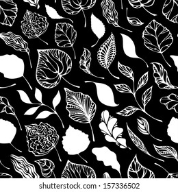 Seamless pattern of leaves. Ornate white leaves on black background. 