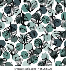 Seamless pattern with leaves and petals on a polka dot background. Vector.