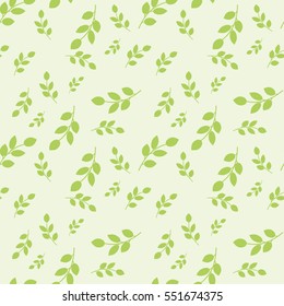Seamless pattern with leaves placed randomly on light green background

