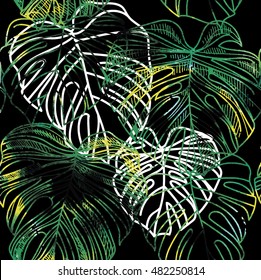 Seamless pattern with leaves of tropical plants . Vector freehand drawing . Background with palm leaf 