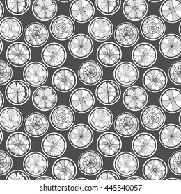 Seamless pattern with lemon, orange and grapefruit white on a dark background. Hand-drawn citrus. Stylized graphics. 