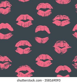 Seamless pattern with lipstick kisses. Imprints of lipstick of light pink shades isolated on a dark grey background. Can be used for design of fabric print, wrapping paper or romantic greeting card