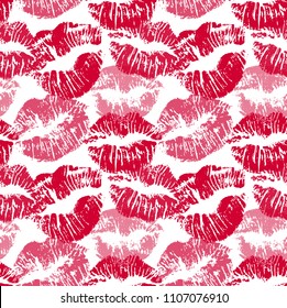 Seamless pattern with lipstick kisses. Lips imprints of red and pink shades isolated on a white background. Endless ornament your print, wrapping or romantic greeting card design. Vector eps 10