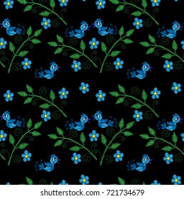 Seamless pattern with little blue bird on the brunch with flower embroidery stitches imitation. Template for fabric, textile, patch or print. Fashion bird and flower embroidery. 
