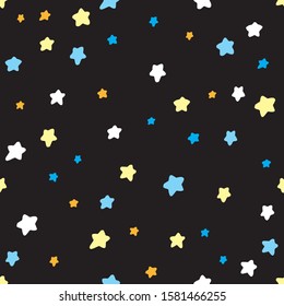 Seamless pattern. Little blue, yellow and white stars on a black background. Textile design.