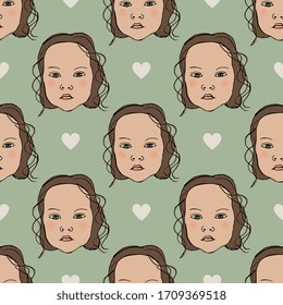 Seamless pattern with little girl faces and heart symbols. Cute baby.