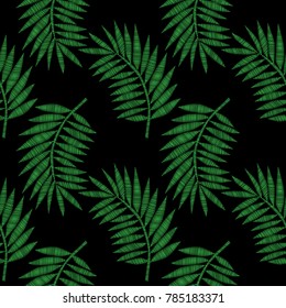 Seamless pattern with little green palm leaf embroidery stitches imitation on the black background. Isolated palm tree leaf.