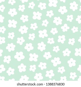 Seamless pattern with little white flowers on green background.