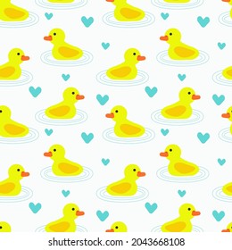 Seamless pattern with little yellow ducks and blue hearts. White background. Vector design