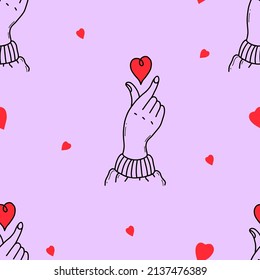 Seamless pattern with love hand gesture with hearts on purple background with hearts. Vector illustration. Linear hand drawn doodle style drawings for design, decoration, wallpaper and textile.