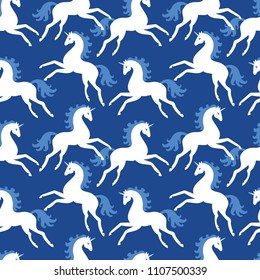 Seamless pattern. Lovely unicorns on a blue background. Fairy animals. Children's print.
