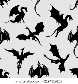 Seamless pattern made up of black dragons and wyverns on the white background. Endless repeating pattern for printing on package, wrappers, textile, envelopes, cards or cloth.