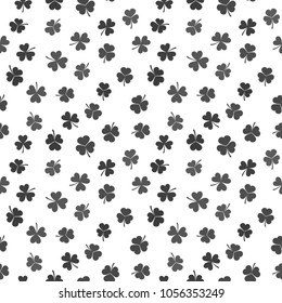 Seamless pattern made from dark shamrocks or clovers. Vector St. Patrick's Day texture