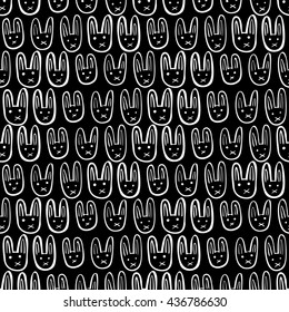Seamless pattern made of illustrated white bunnies on black