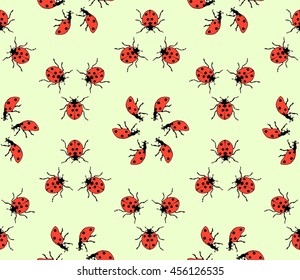 seamless pattern made from ladybugs on green background