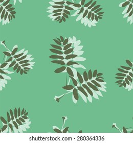 Seamless pattern made of leaves on a green background