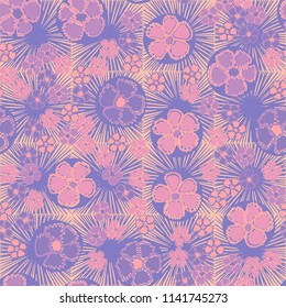 A seamless pattern made up of primitive drawings of multicolored flowers.
The picture is located on a background of a texture consisting of square suns.