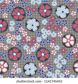 A seamless pattern made up of primitive drawings of multicolored flowers.
The picture is located on a background of a texture consisting of four-beam stars inscribed in squares.