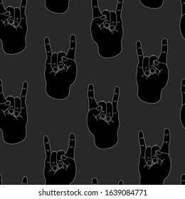 Seamless pattern man hand shows rock and roll gesture on a gray background .Vector illustration of a metal sign in a flat style. Design for background, fabric, wallpaper, stickers.