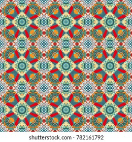 Seamless pattern mandala ornament. Tribal motifs. Vintage decorative elements in orange, blue and beige colors. Vector oriental background in saturated colors.