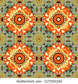 Seamless pattern from mandalas painted in yellow, orange and beige colors. Vector abstract geometric kaleidoscopic mandala design symbol - symmetric.