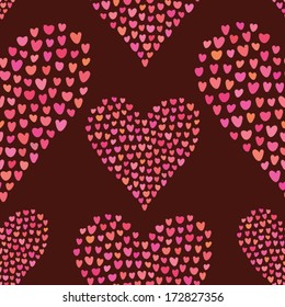 Seamless pattern of many little hearts in the shape of hearts on chocolate background