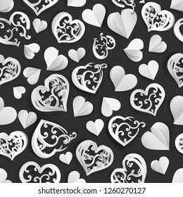 Seamless pattern of many paper volume hearts with holes, white on black