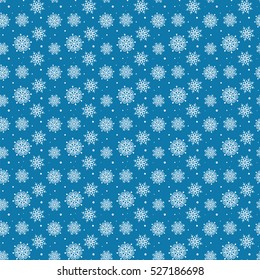 Seamless pattern of many white snowflakes on blue background. Christmas winter theme for gift wrapping. New Year seamless background for website