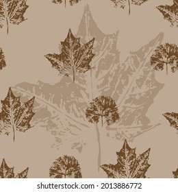 Seamless pattern with maple leaves on a gentle brown background. Grunge leaf print. Printing on fabric, wallpaper, packaging, stylized as a stamp or leaf print