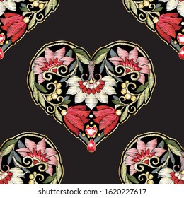 Seamless pattern with mbroidered love heart-shaped patch with a floral pattern in vintage style with rhinestones and sparkles. Vector illustration isolated on black background.