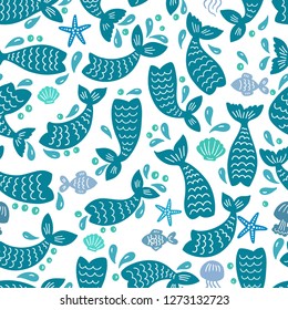 Seamless pattern with mermaid tails, starfishes, jellyfishes, shells. Blue nursery background. Childish design. Perfect for textile, apparel, fabric, wrapping, wallpaper.  Vector illustration.