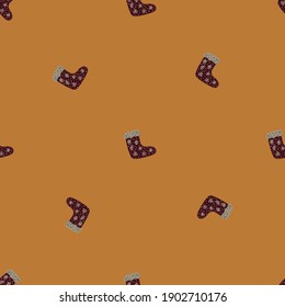 Seamless pattern in minimalistic style with doodle brown sock ornaments. Beige background. Simple design. Vector illustration for seasonal textile prints, fabric, banners, backdrops and wallpapers.