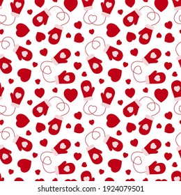 Seamless pattern from mittens and hearts on a white background.