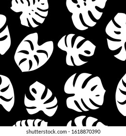Seamless pattern with monstera leaves. Exotic plant white silhouettes on black background. Flat vector illustration.